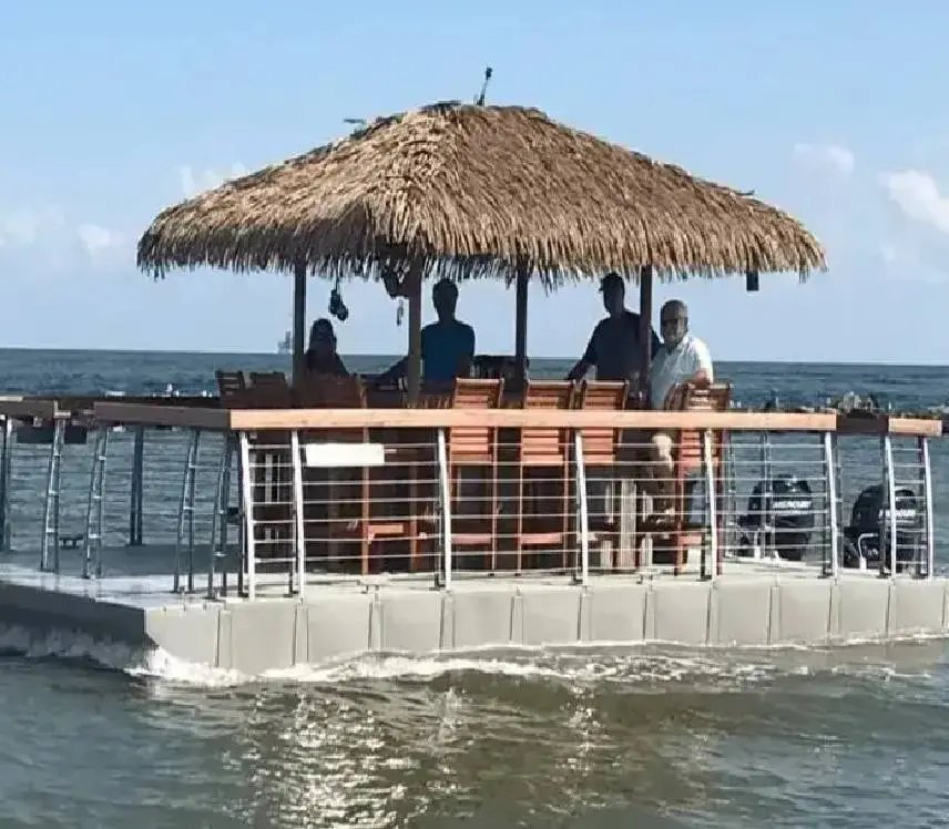 A group of people sitting at the top of a pier.